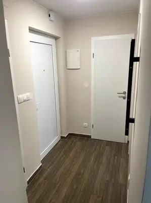 an empty room with two doors and a wooden floor at Apartment in Maribor in Maribor