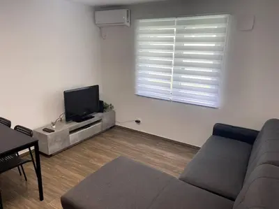 a living room with a couch and a flat screen tv at Apartment in Maribor in Maribor