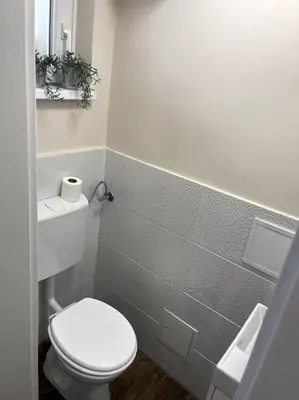 a bathroom with a white toilet and a sink at Apartment in Maribor in Maribor