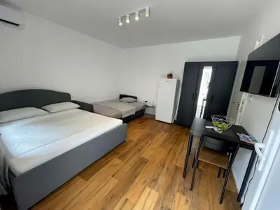 a bedroom with a bed and a table in it at Ljubljana Studios in Ljubljana