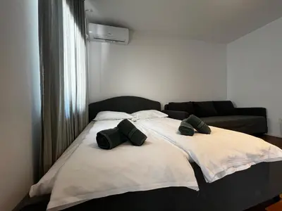 a bed in a room with two pillows on it at Ljubljana Studios in Ljubljana