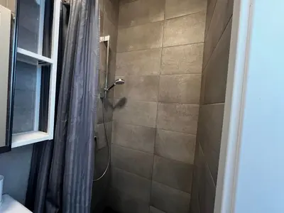 a bathroom with a shower with a shower curtain at Ljubljana Studios in Ljubljana