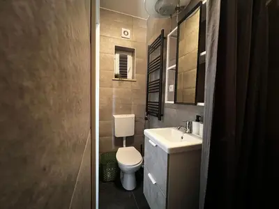 a bathroom with a toilet and a sink at Ljubljana Studios in Ljubljana