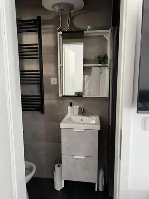 a small bathroom with a sink and a mirror at Ljubljana Studios in Ljubljana