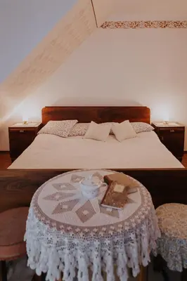 a bedroom with a bed with a table with a cake on it at Koroška hiša Pri lipi, Boutique hotel in Muta