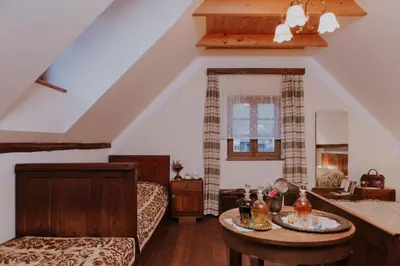 a living room with a couch and a table at Koroška hiša Pri lipi, Boutique hotel in Muta