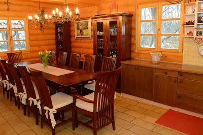 a dining room with a wooden table and chairs at Luxury Chalet at Podlipje Estate in Tešanovci