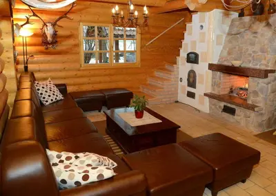 a living room with a couch and a fireplace at Luxury Chalet at Podlipje Estate in Tešanovci