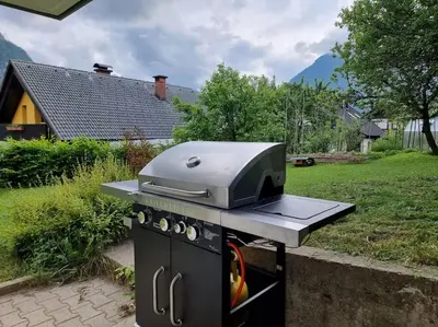 a grill with a toaster on top of a stove at Comfy mountain nest in Mojstrana