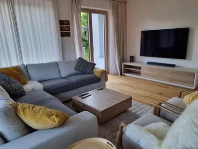 a living room with a couch and a tv at Comfy mountain nest in Mojstrana
