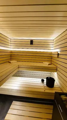 a sauna with a bowl sitting on a shelf at TEMPFER Apartments & Rooms with new WELLNESS in Rateče
