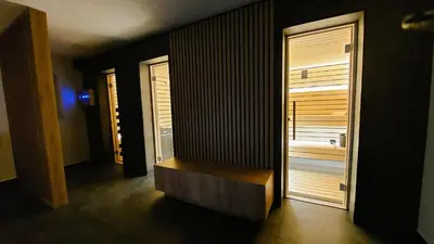 a hallway with a wooden bench in a room at TEMPFER Apartments & Rooms with new WELLNESS in Rateče