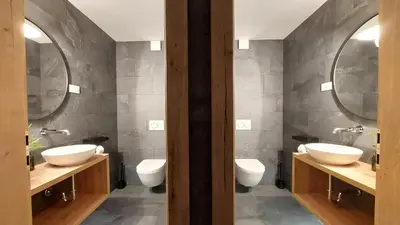a bathroom with three sinks and two mirrors at TEMPFER Apartments & Rooms with new WELLNESS in Rateče