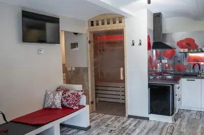 a living room with a bench and a kitchen at Apartma in wellness Čista fantazija in Velika Polana