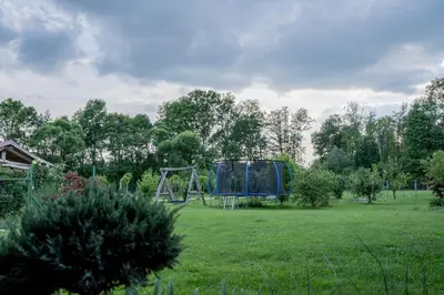 a park with a playground in the middle of a field at Apartma in wellness Čista fantazija in Velika Polana