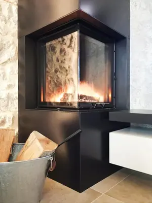 a fireplace in a kitchen with a fire place at Casa Matko in Kostanjevica na Krasu