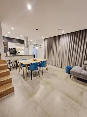 a kitchen and dining room with a table and chairs at Casa Matko in Kostanjevica na Krasu