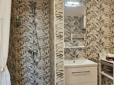 a bathroom with a toilet and a sink and a wall at Ljubljana Park Apartments Bolero in Ljubljana