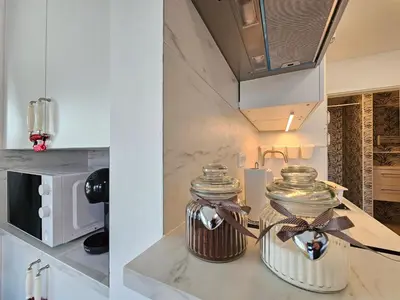 two glass jars on a counter in a kitchen at Ljubljana Park Apartments Bolero in Ljubljana