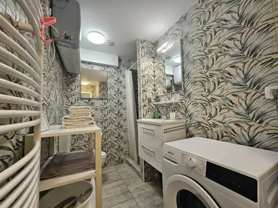 a laundry room with a washer and dryer in it at Ljubljana Park Apartments Bolero in Ljubljana