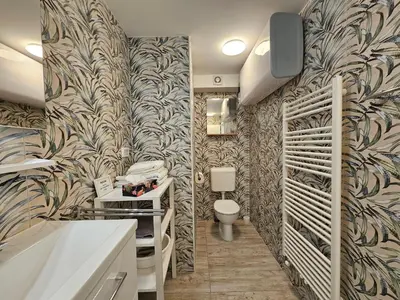 a bathroom with a sink and a toilet in a room at Ljubljana Park Apartments Bolero in Ljubljana