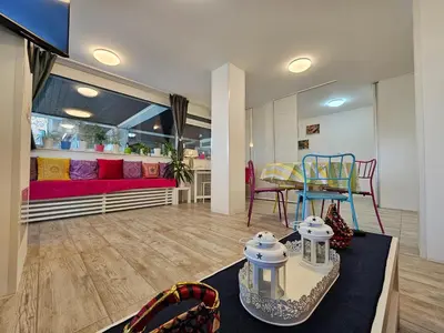 a living room with a couch and a table with chairs at Ljubljana Park Apartments Bolero in Ljubljana