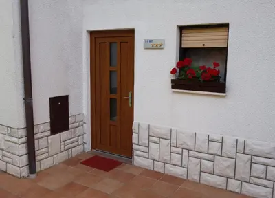 a door of a building with a window with a flower box at Sobe Vera in Bovec