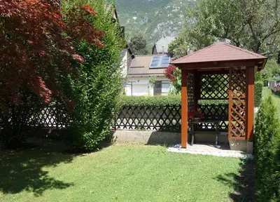 a gazebo sitting in a yard next to a house at Sobe Vera in Bovec