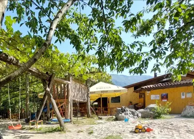 a house with a playground in front of it at Mobilna hiška Lebanč in Breginj