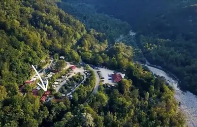 an aerial view of a park in the middle of a forest at Mobilna hiška Lebanč in Breginj
