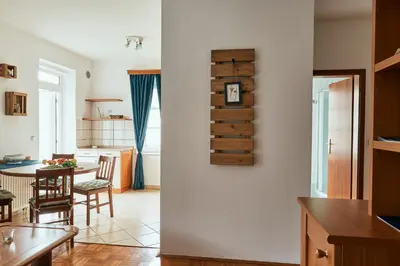 a kitchen and a living room with a table at Rooms & Restaurant Ostarija in Dolenjske Toplice