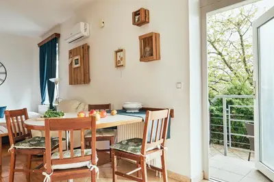 a kitchen and dining room with a table and chairs at Rooms & Restaurant Ostarija in Dolenjske Toplice