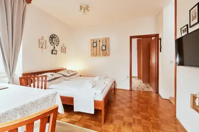 a bedroom with a bed and a television in it at Rooms & Restaurant Ostarija in Dolenjske Toplice