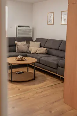 a living room with a couch and a table at Apartmaji Ježek Kope in Šmartno pri Slovenj Gradcu