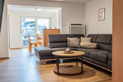 a living room with a couch and a table at Apartmaji Ježek Kope in Šmartno pri Slovenj Gradcu