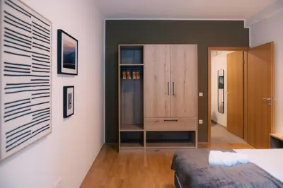 a bedroom with a bed and a cabinet at Peak Haven apartments, Pohorje in Pohorje