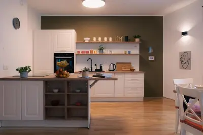 a kitchen with white cabinets and a counter top at Peak Haven apartments, Pohorje in Pohorje