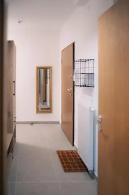 a hallway with a bathroom with a door and a mirror at Peak Haven apartments, Pohorje in Pohorje