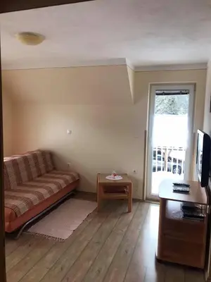 a living room with a couch and a table at Apartmaji Misotič in Gozd Martuljek