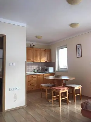 a kitchen with a table and chairs in a room at Apartmaji Misotič in Gozd Martuljek