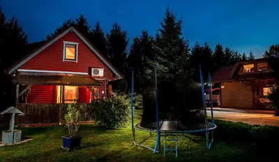 a house with a trampoline in front of a house at Apartments Brunarica in Moravske Toplice