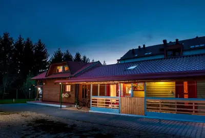 a house with lights on in front of it at Apartments Brunarica in Moravske Toplice