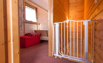 a room with a gate in a wooden cabin at Apartments Brunarica in Moravske Toplice