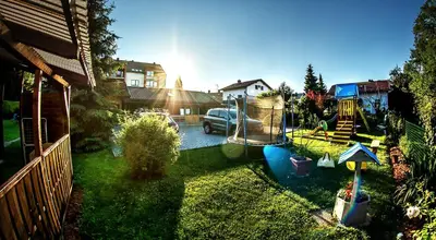 a yard with a playground with a car and a house at Apartments Brunarica in Moravske Toplice