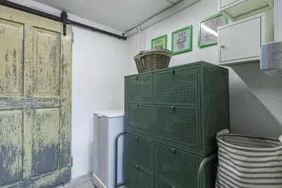 a green cabinet in a laundry room with a door at Alpine House Naturalina - Happy Rentals in Slappe dʼIdria