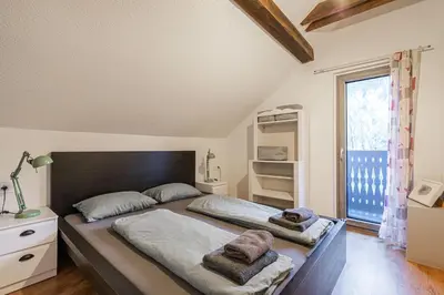 a bedroom with two beds and a window at Alpine House Naturalina - Happy Rentals in Slappe dʼIdria