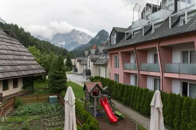 a view from a balcony of a house with a garden at Alpine Spot in Kranjska Gora