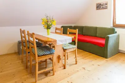 a living room with a table and chairs and a couch at Alpine Spot in Kranjska Gora