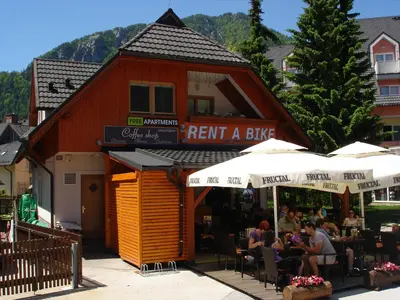 a restaurant with people sitting outside of a building at Alpine Spot in Kranjska Gora