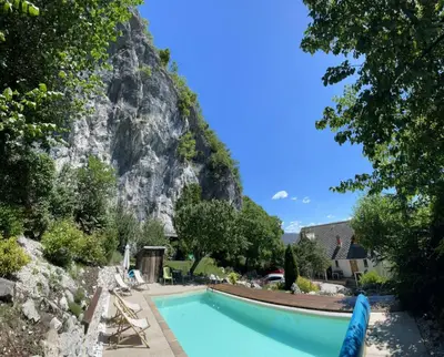 a swimming pool with a mountain in the background at Holiday Home Katričnek in Bohinjska Bela
